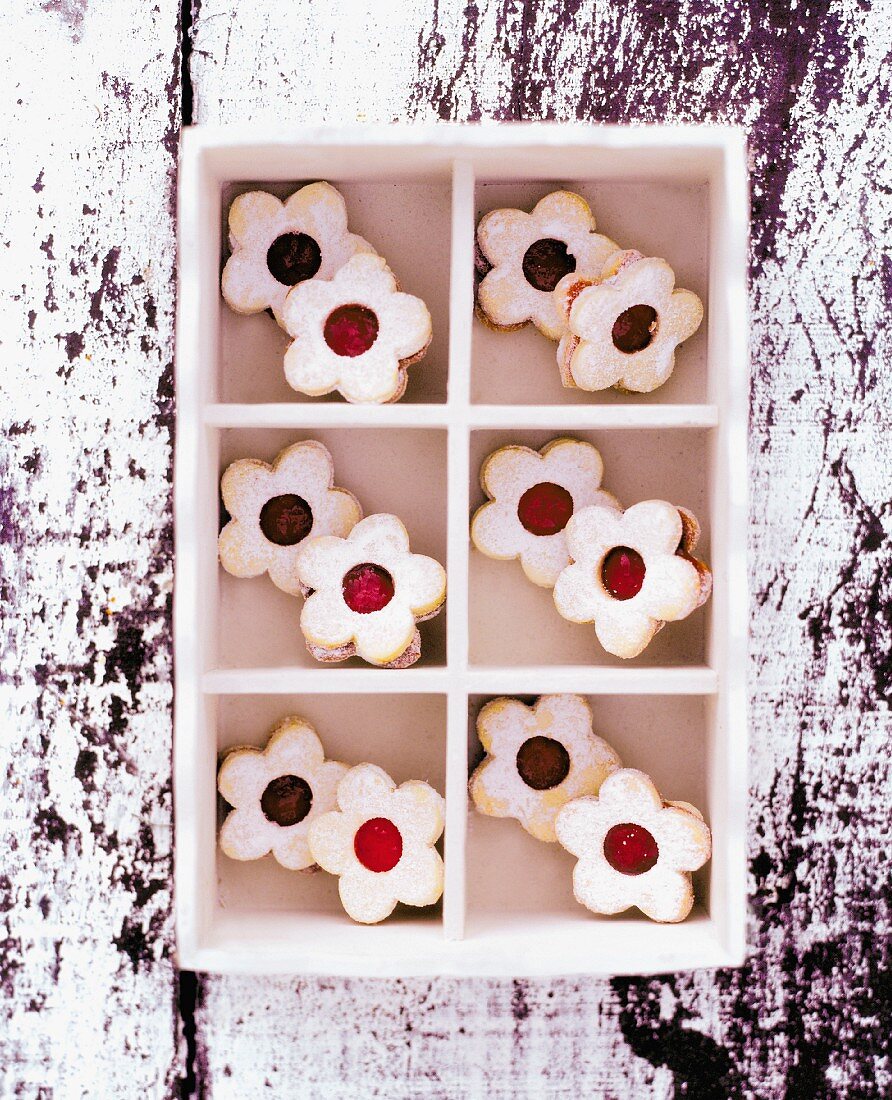 Flower-shaped jam biscuits in a seedling tray