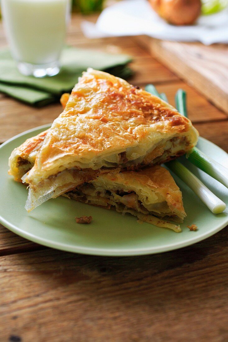 Two slices of meat and spring onion pie