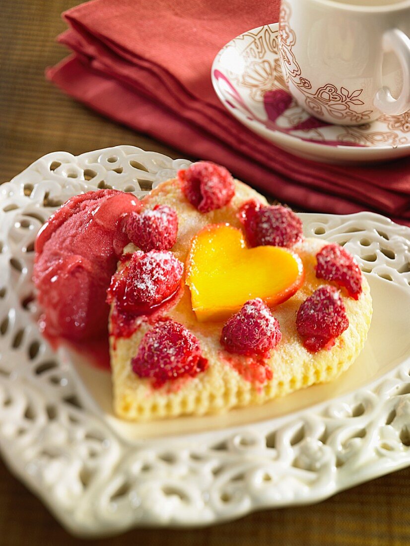 A heart-shaped Madeira cake with raspberries