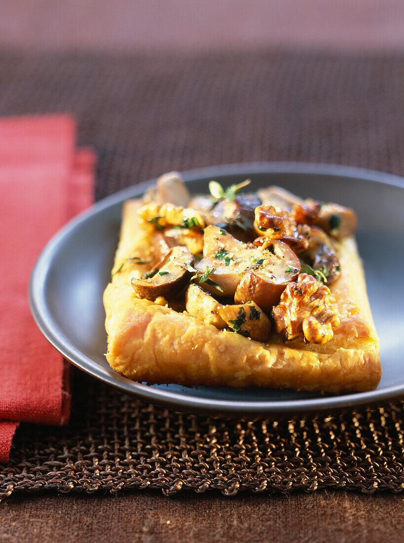 Flaky pastry tart with ceps and walnuts