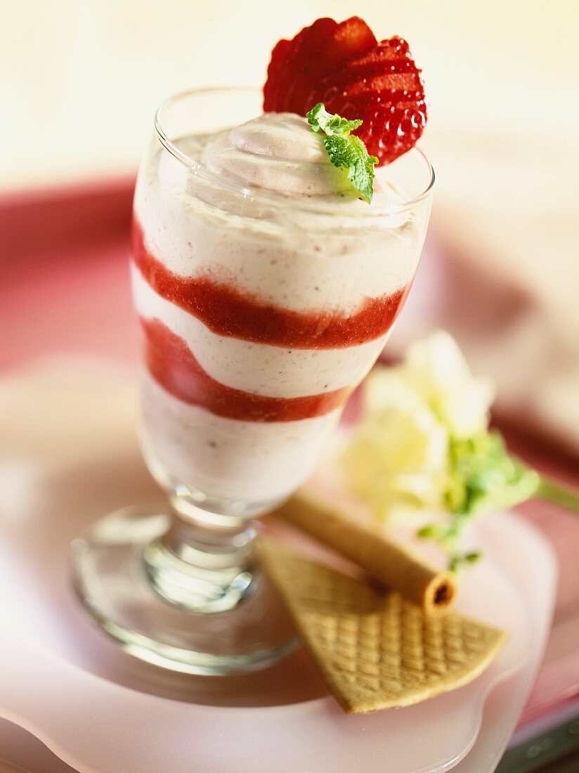 A layered dessert with cream cheese and strawberries