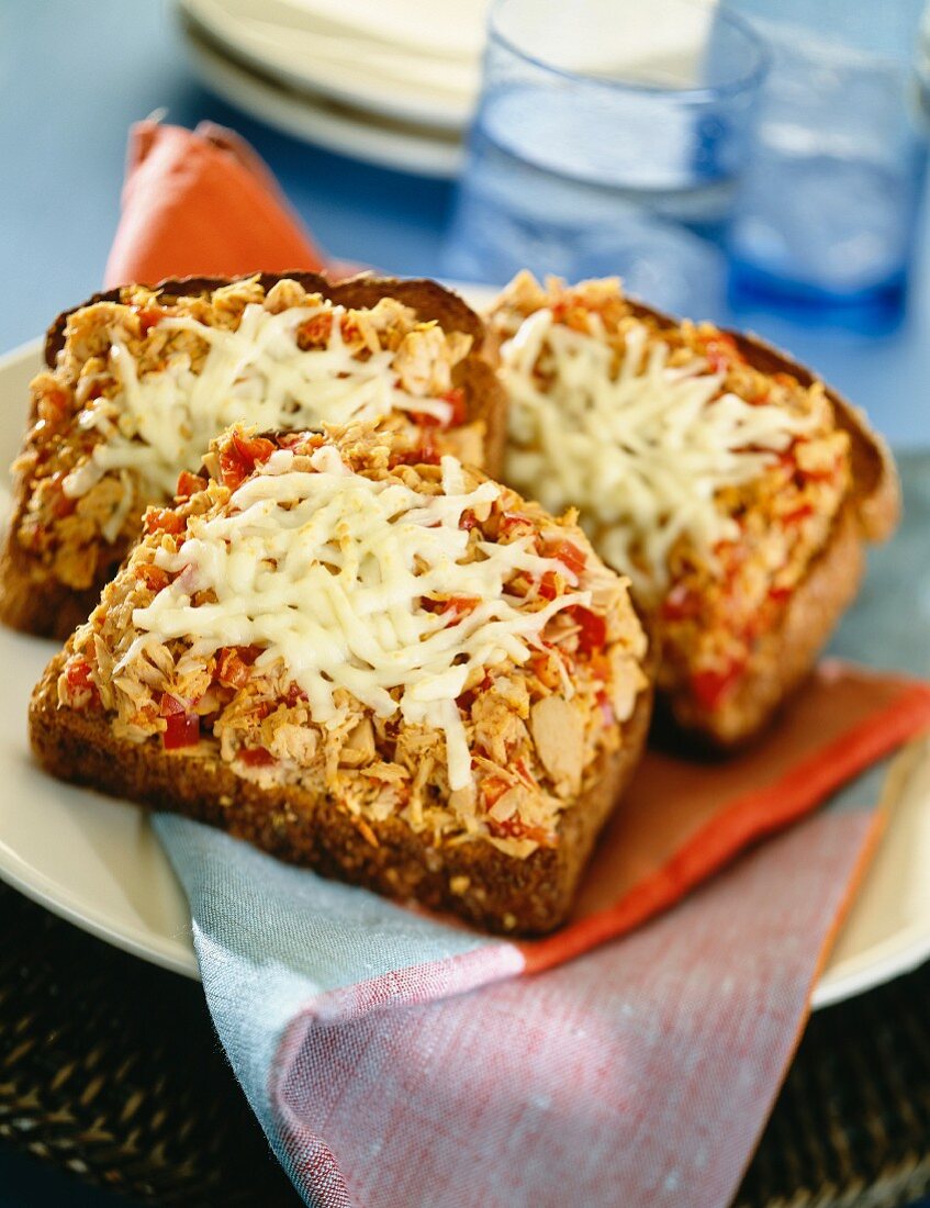 Open, toasted tuna fish sandwiches with melted cheese