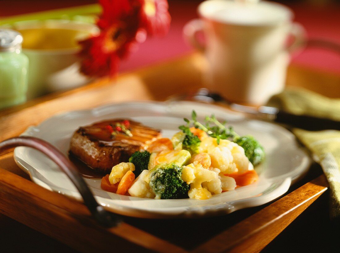 Grilled beef steak with a red wine sauce and vegetables