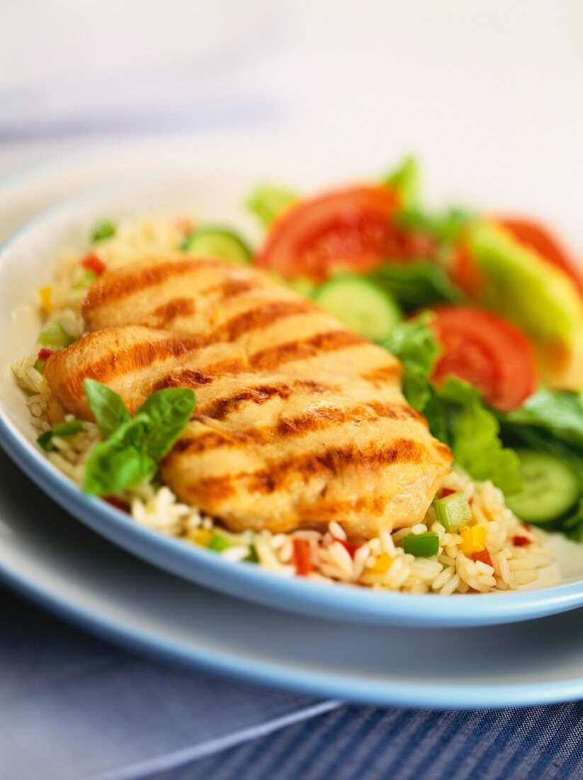 Grilled chicken escalope on pepper rice with salad