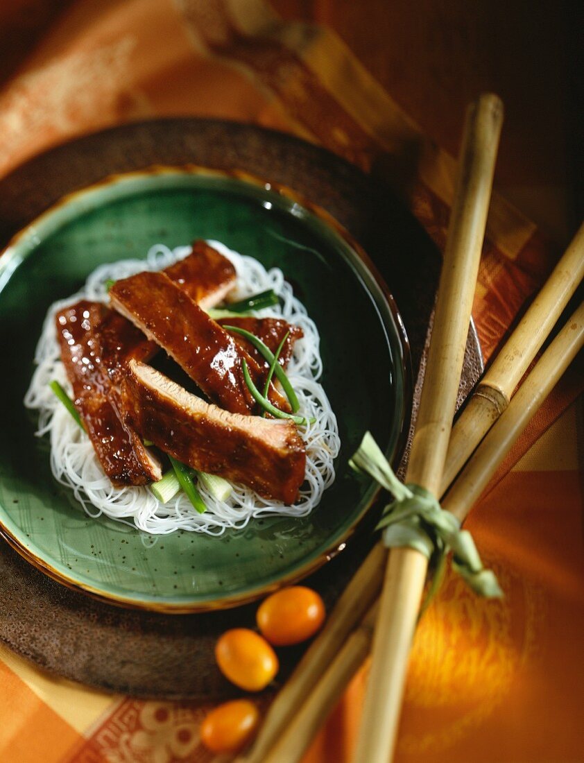 Glazed pork on a bed of rice noodles