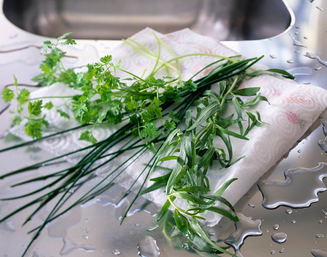 Washed herbs on a draining board