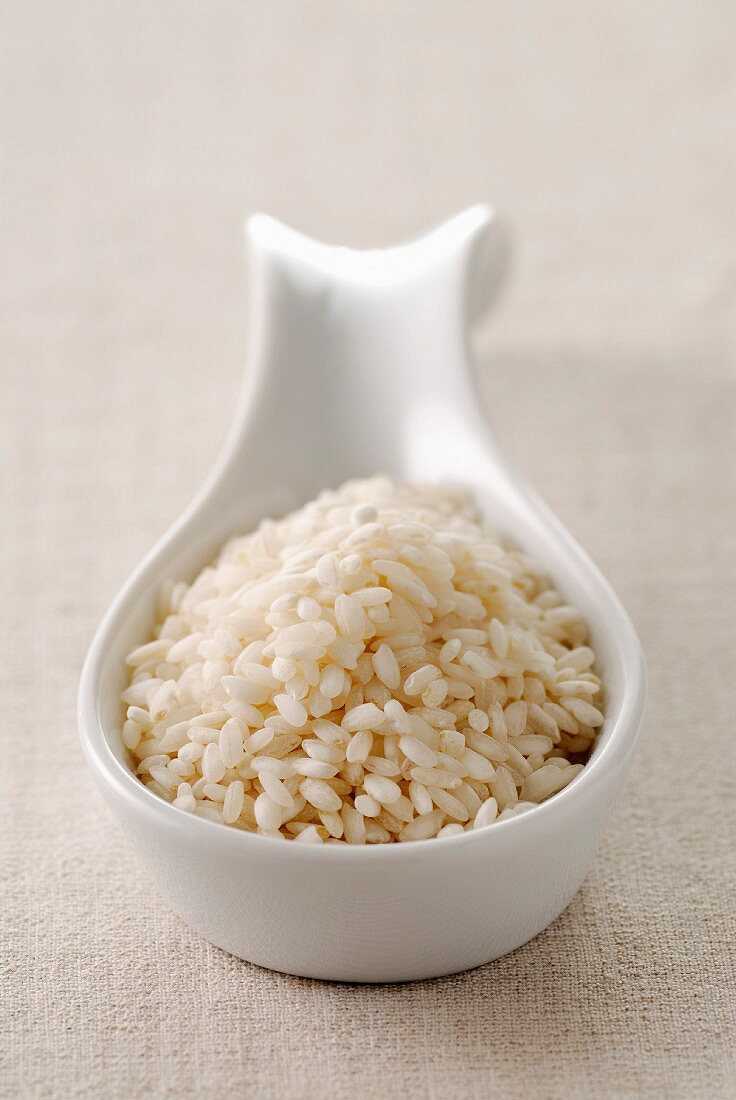 Risotto rice on a porcelain spoon