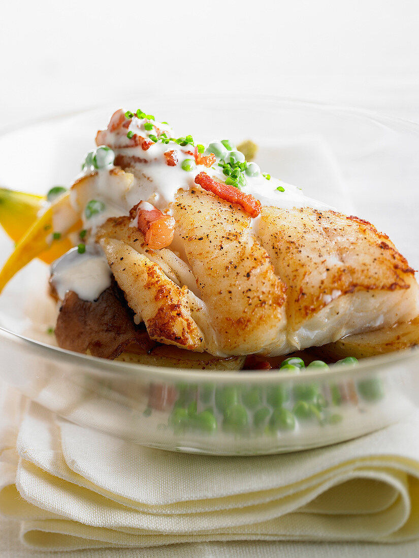Roast cod with spicy light cream sauce and peas