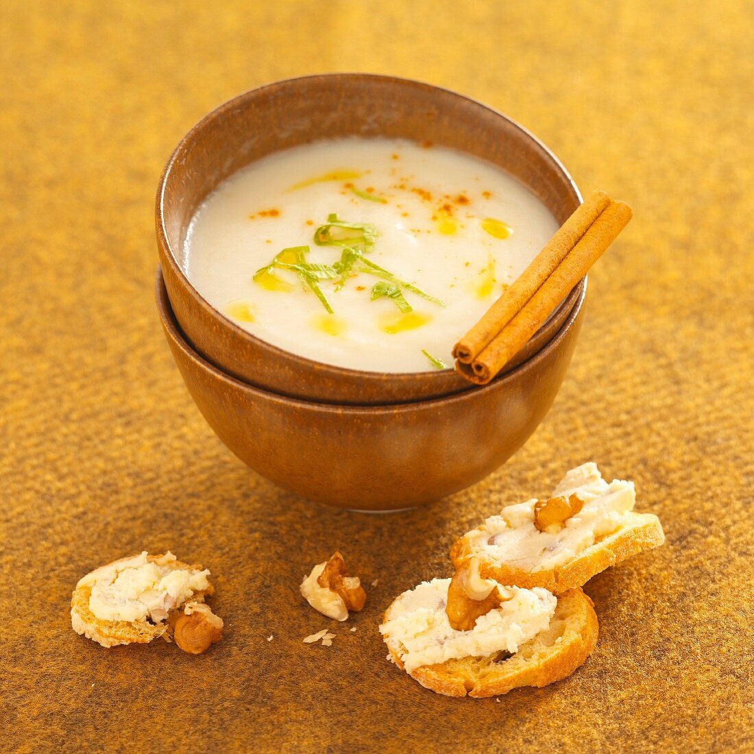 Cream of celeriac soup with croutons topped with cheese and walnuts