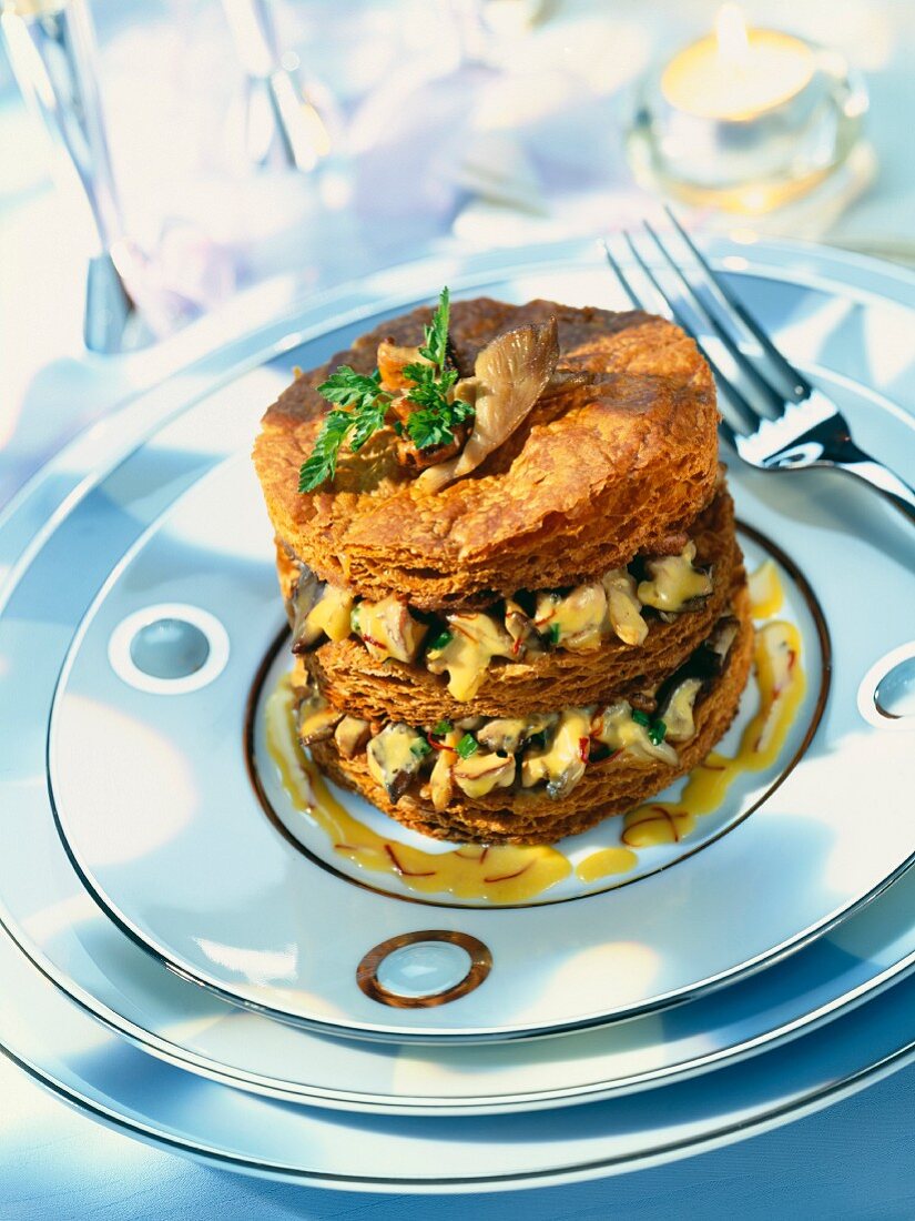 A layered cake with wild mushrooms and saffron sauce