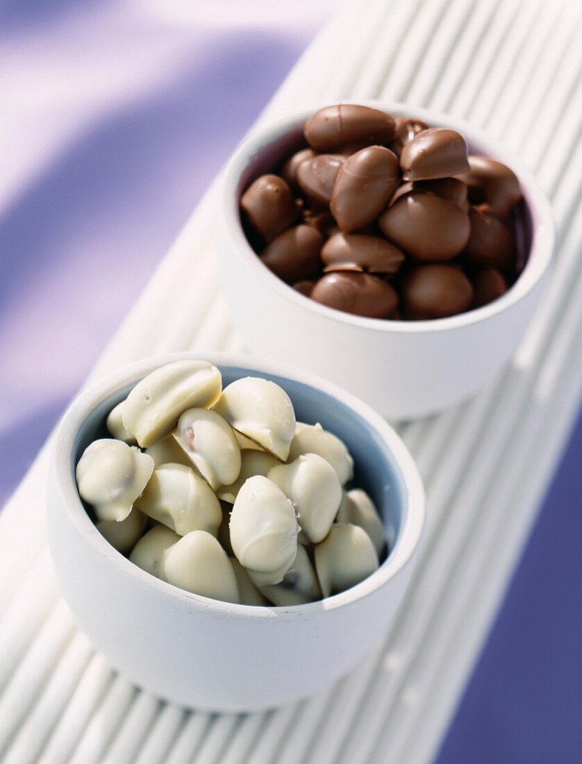 Two types of chocolate almonds in bowls