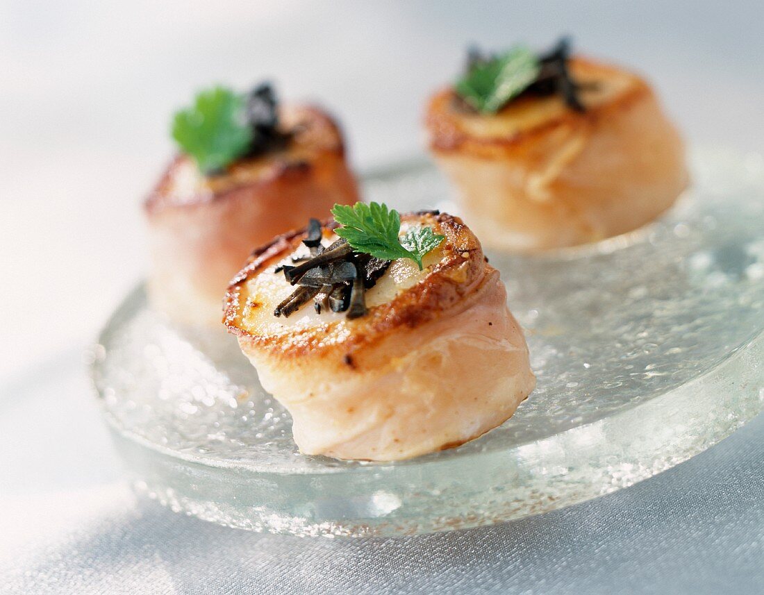 Scallops wrapped in bacon with truffles