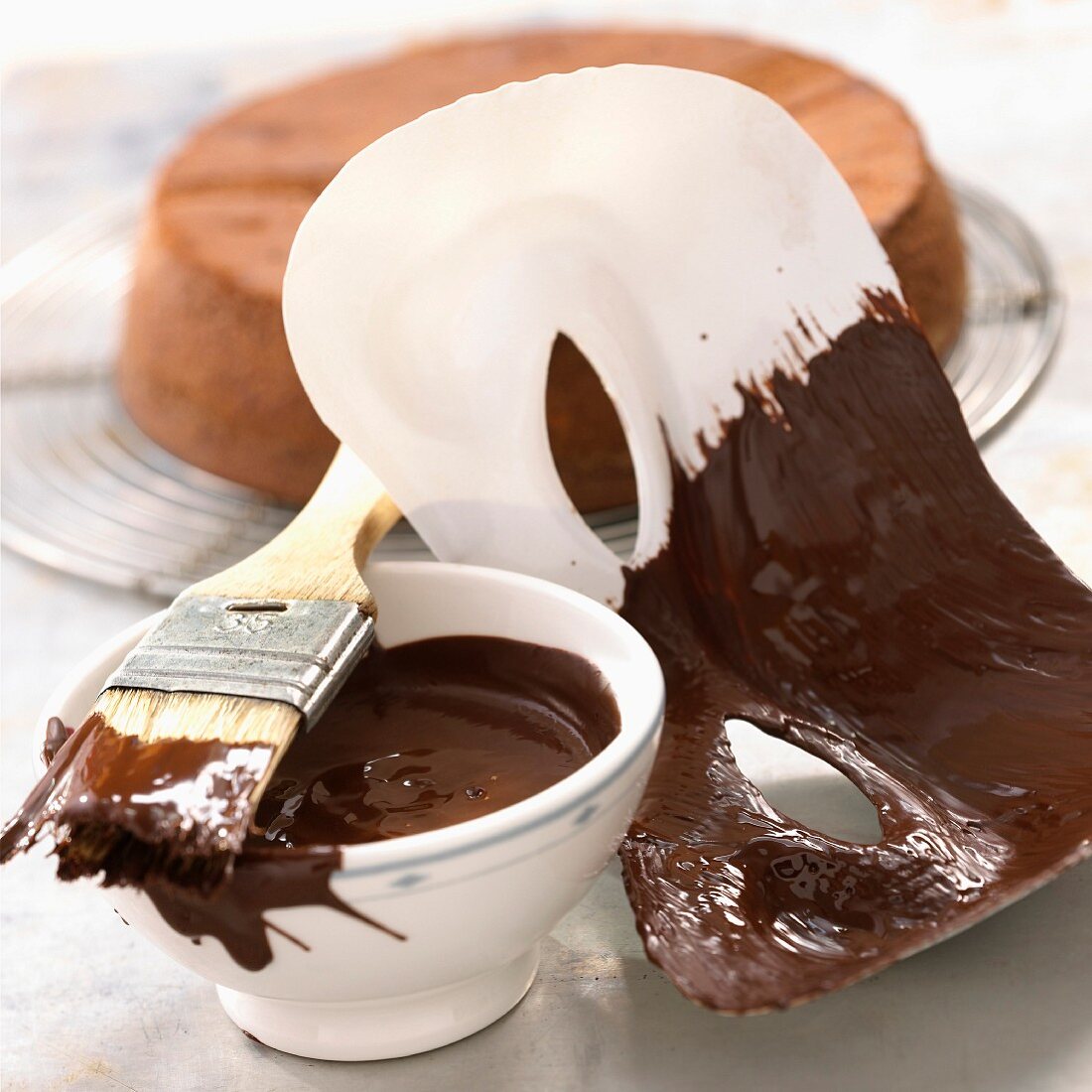 A mask being brushed with chocolate