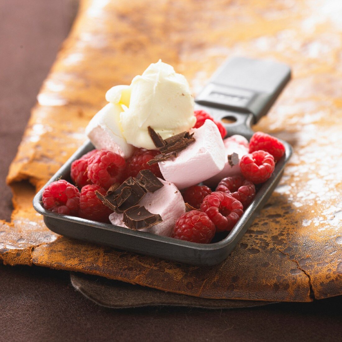 Marshmallow raclette with raspberries