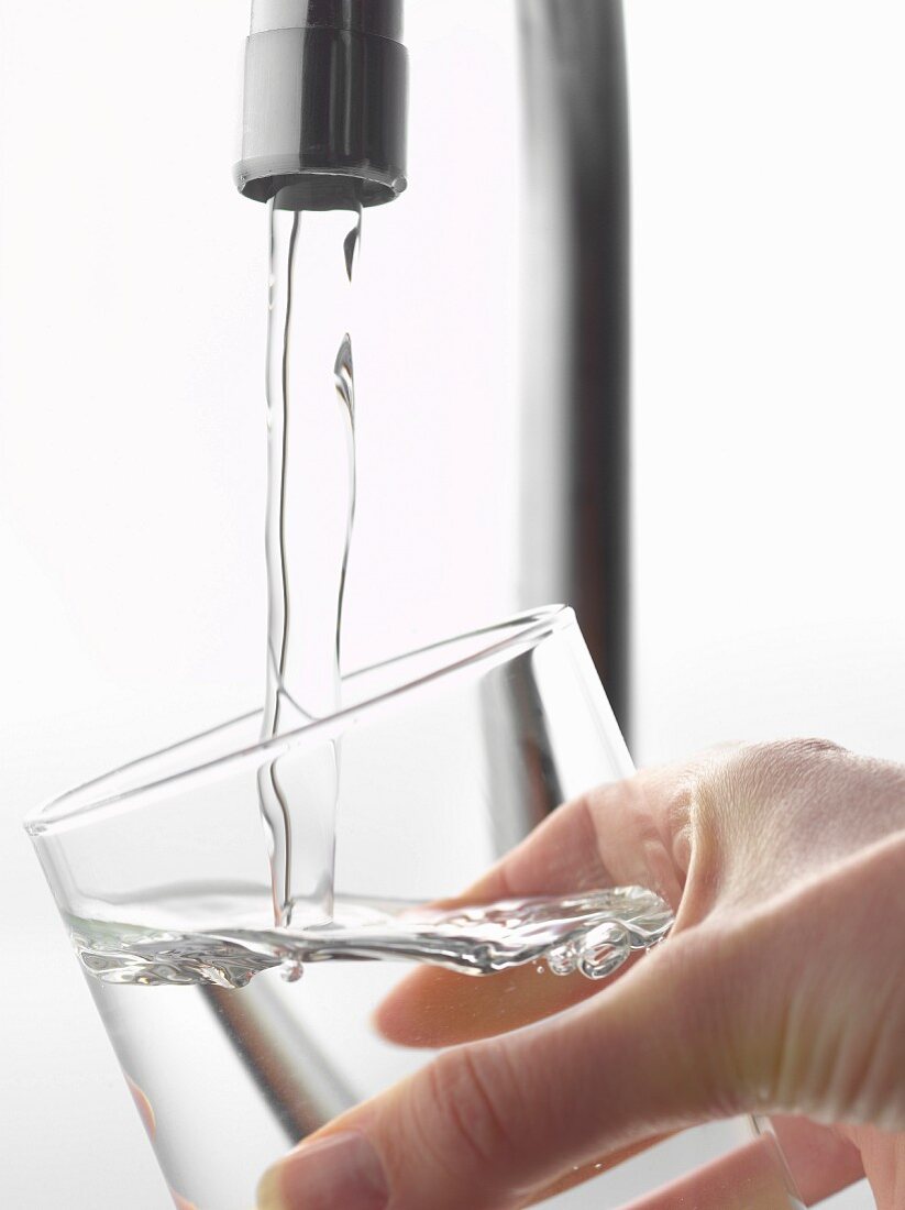 Filling a glass of water from the tap