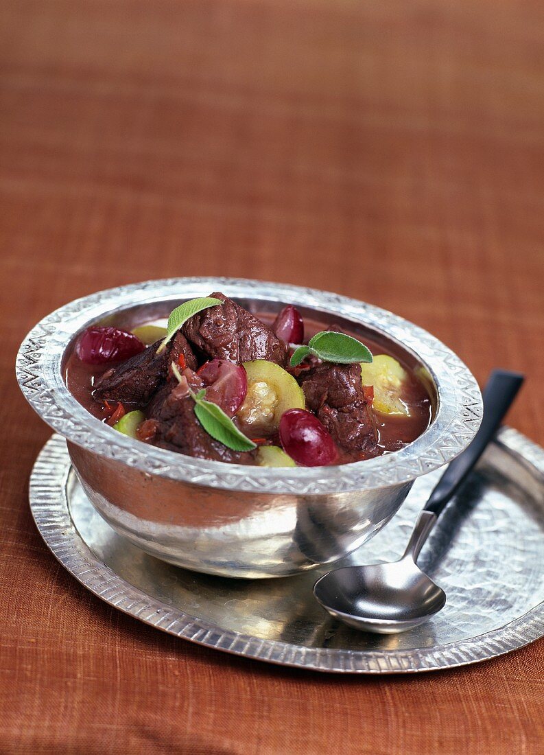 Doe stewed in red wine with raisins and zucchinis