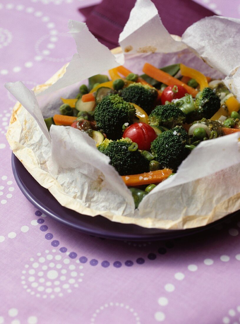 Young vegetables with pesto on parchment paper
