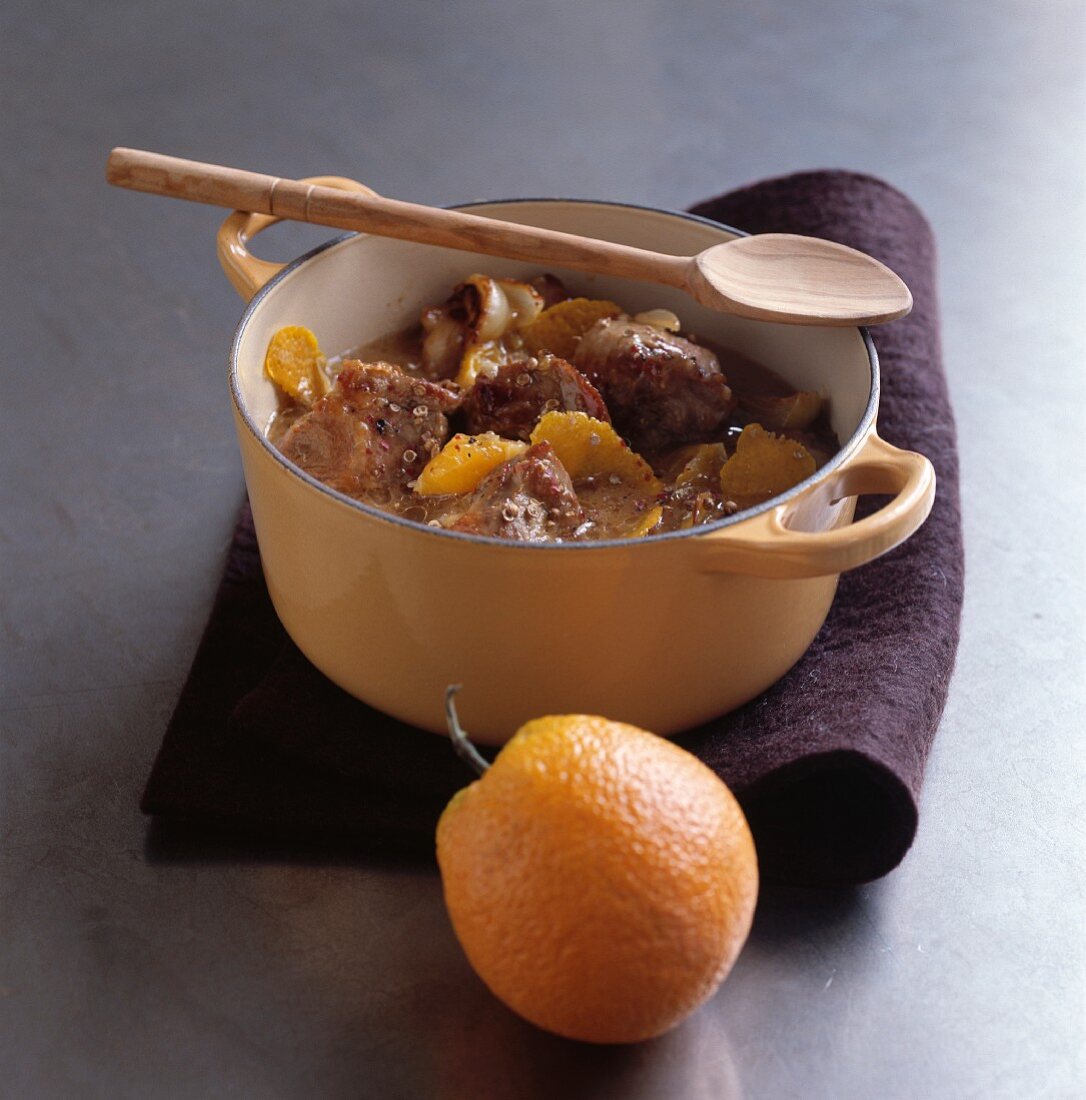 Pork collar with a white berry sauce and oranges