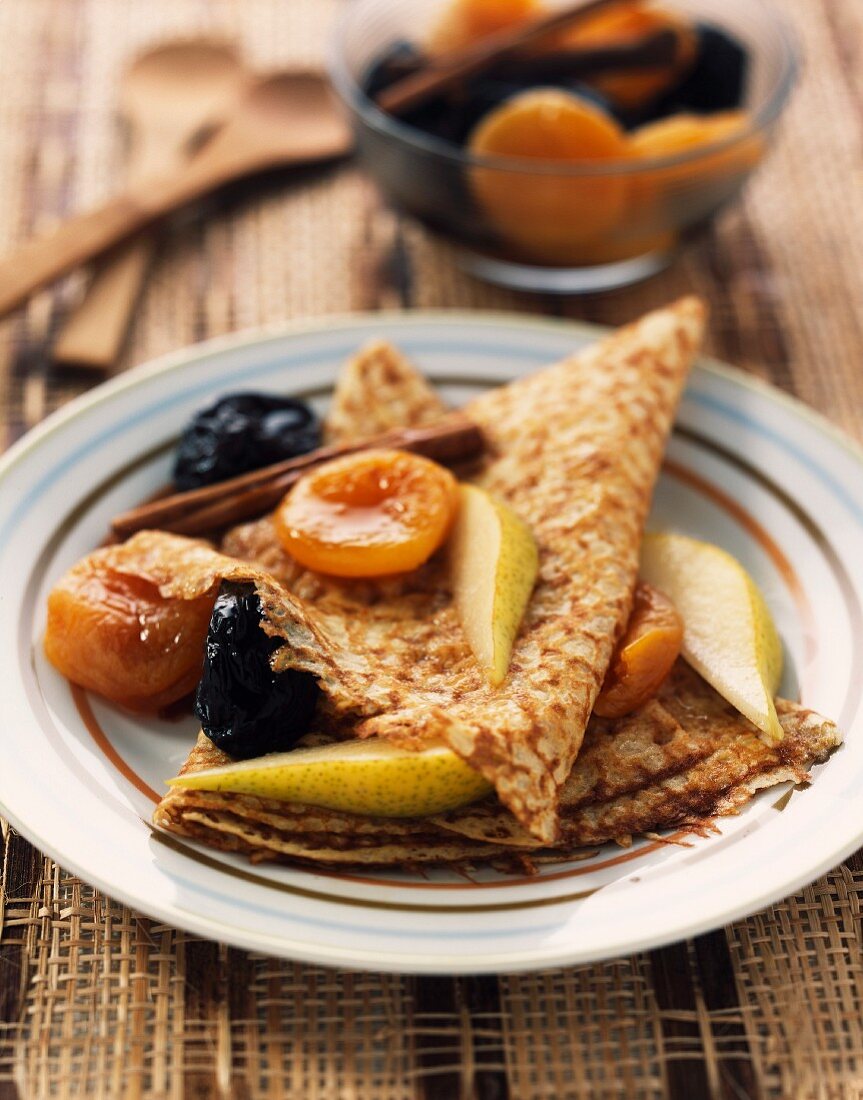 Pancakes with warm stewed dried fruit