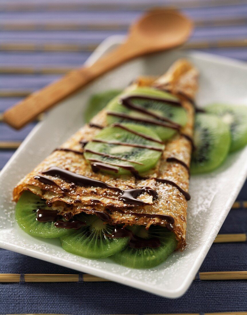Pancake with melted chocolate and kiwi