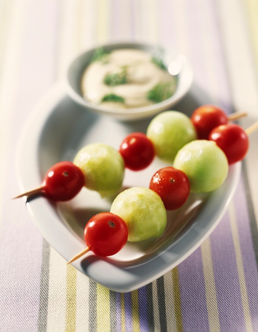 Cucumber balls and cherry tomato brochettes with dip
