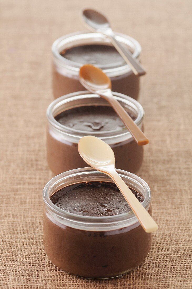 Small pots of dark chocolate cream desserts