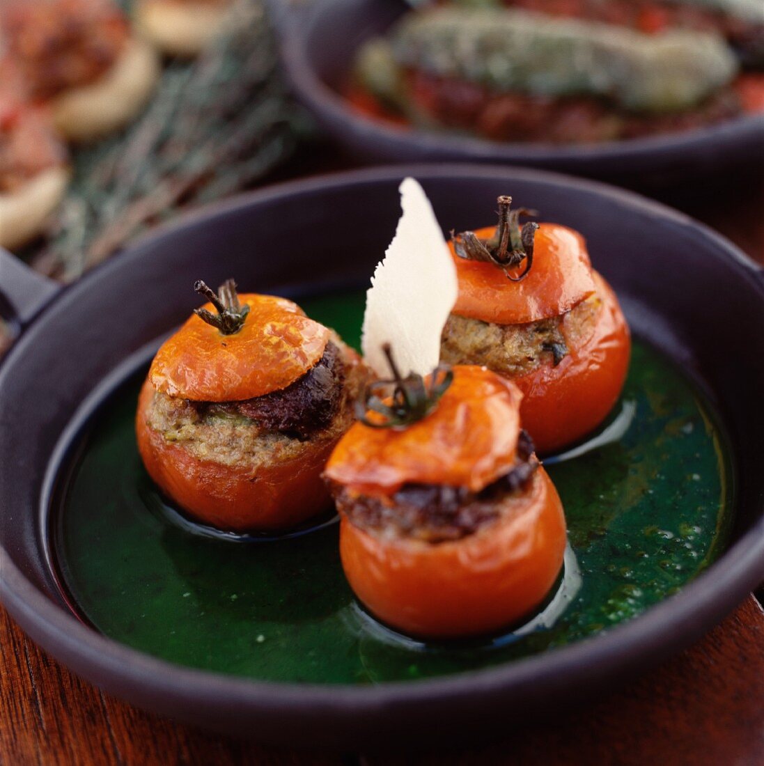 Stuffed tomatoes with Parmesan in a green sauce