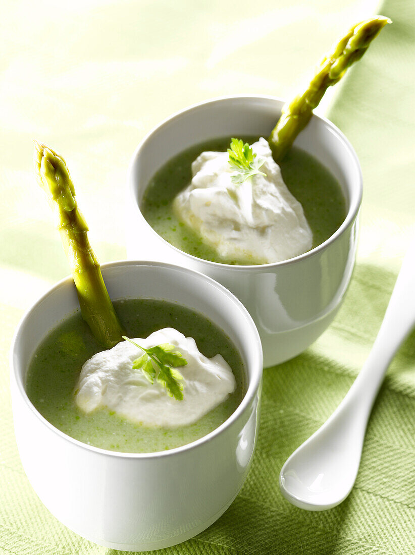 Cream of green asparagus soup with whipped chervil cream