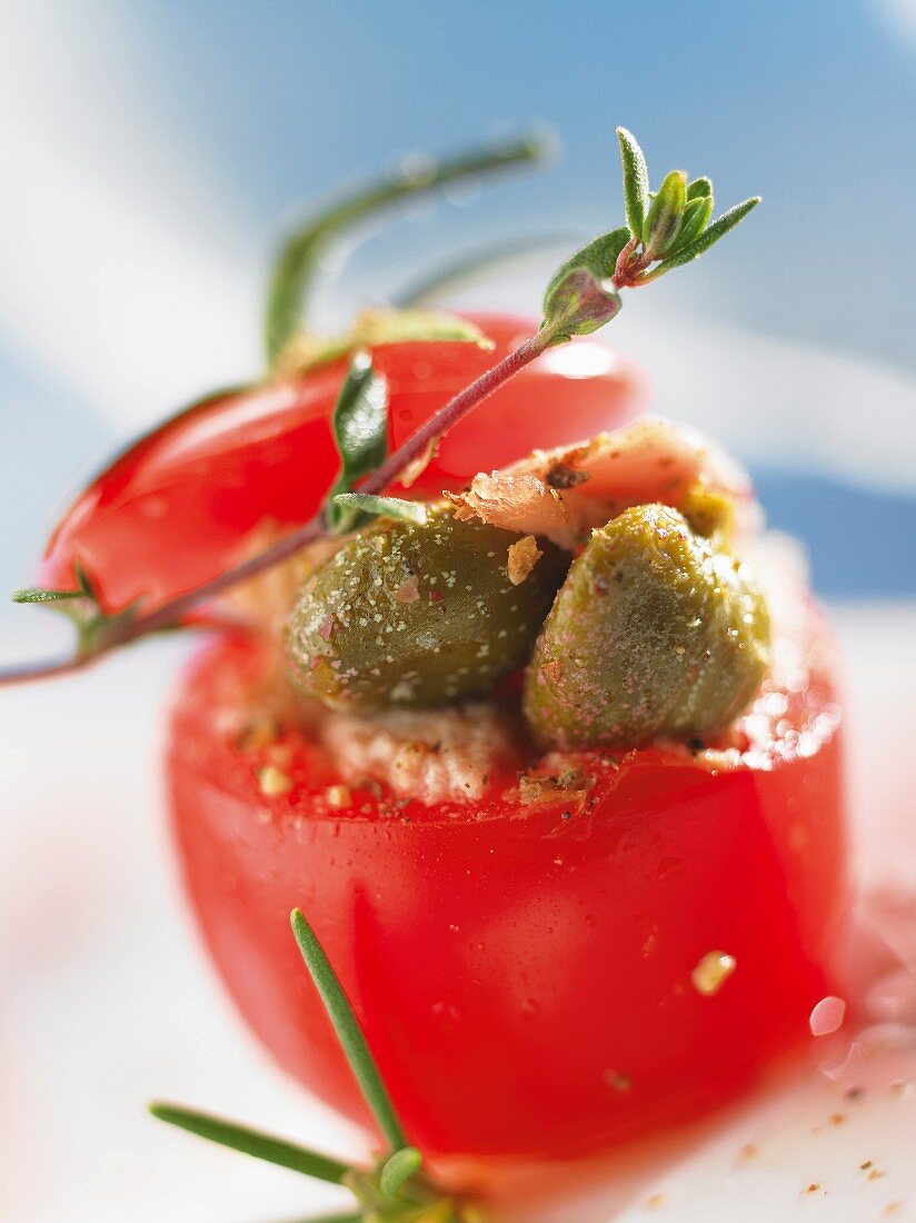 A stuffed tomato filled with capers