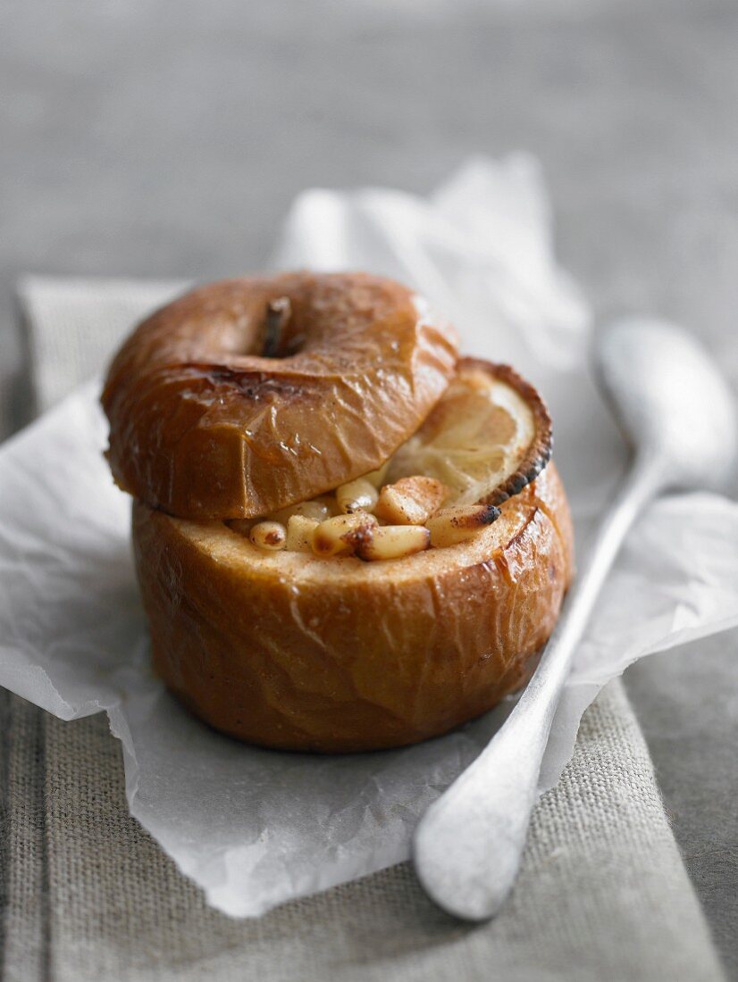 A baked apple filled with pine nuts and lemon