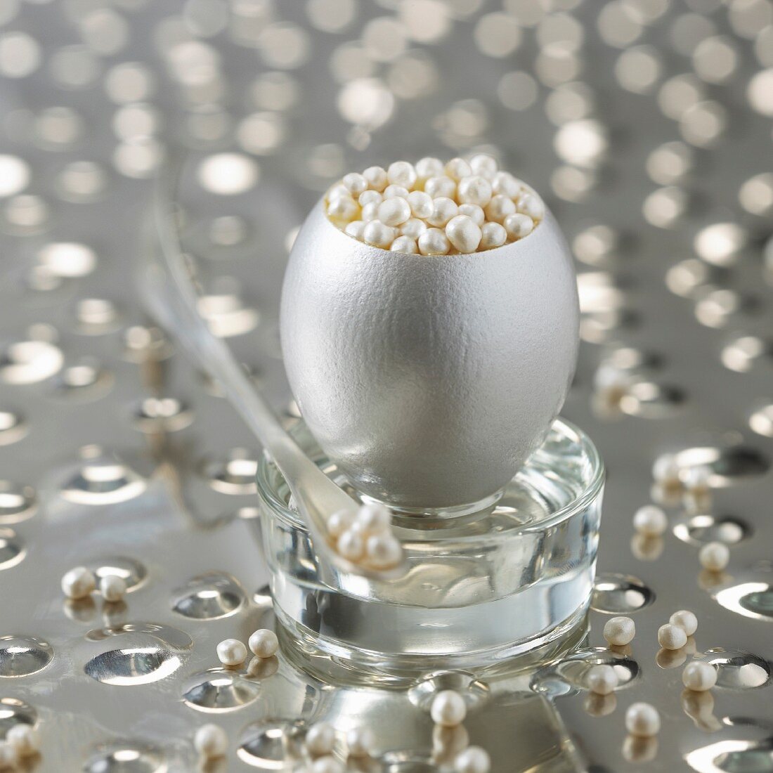 Decorative silver egg filled with shiny pearls