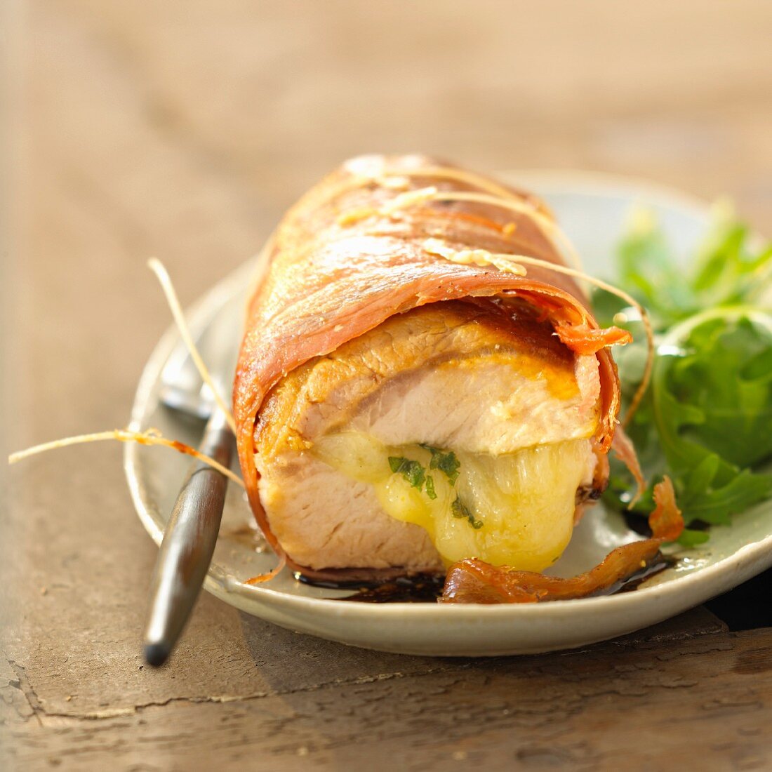 Rolled pork fillet garnished with ham and Comté cheese