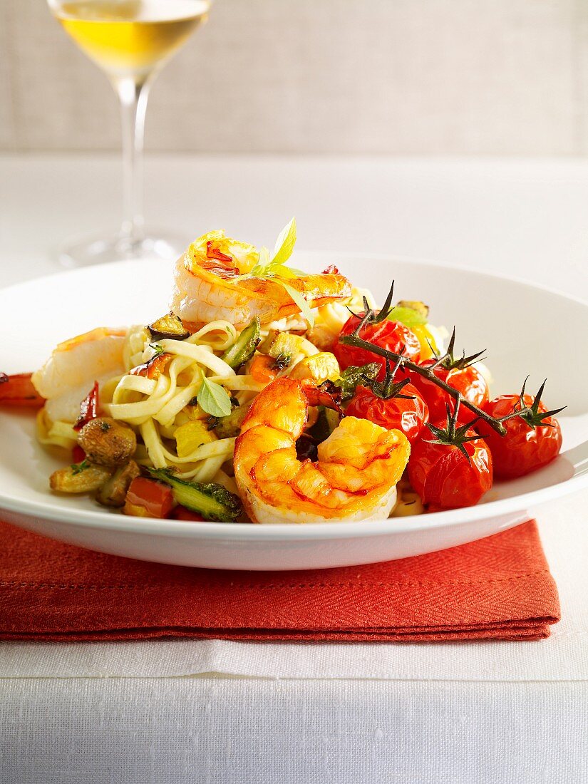 Sauteed gambas with linguine and summer vegetables