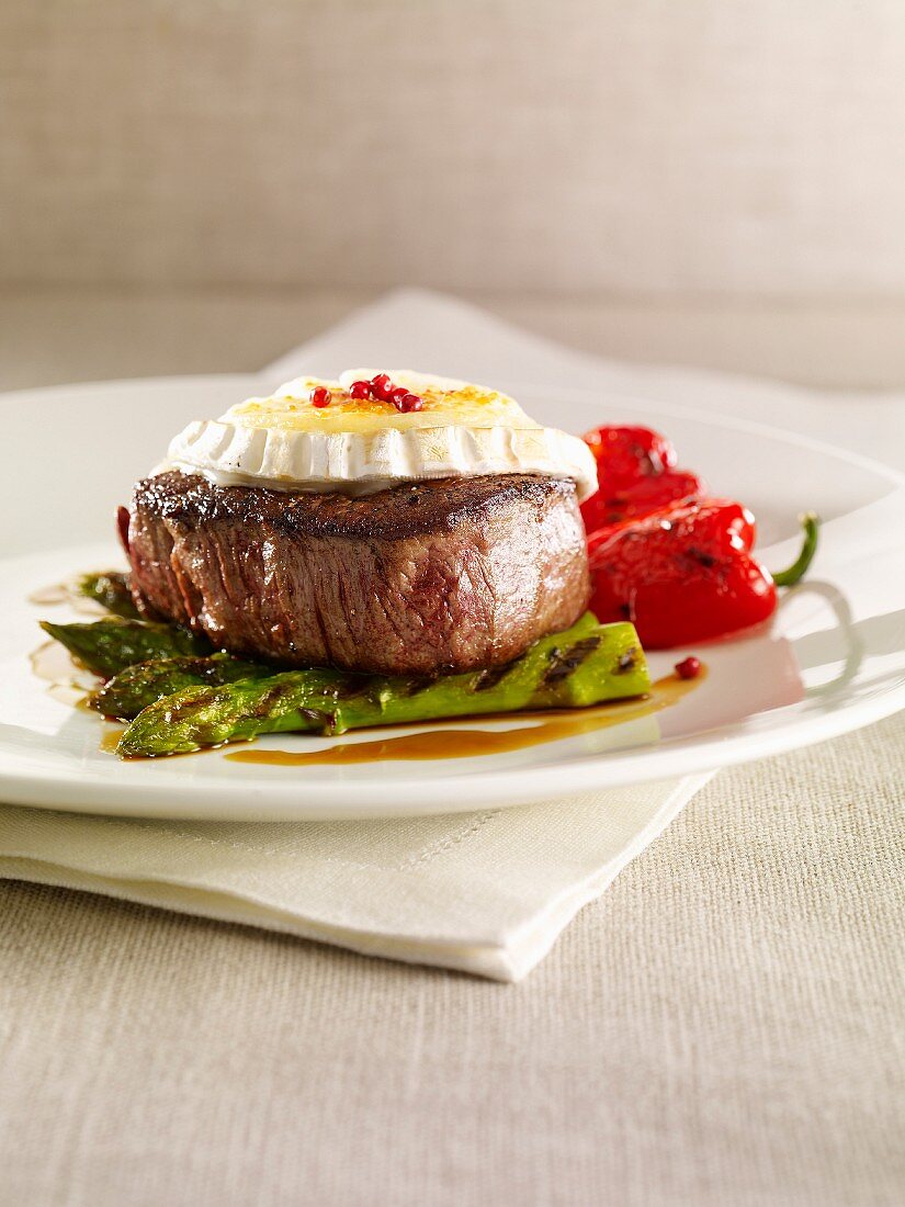 Tournedos topped with goat's cheese and on a bed of green asparagus
