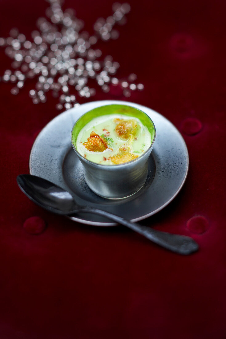 Cream of split pea soup with raviolis and walnut oil