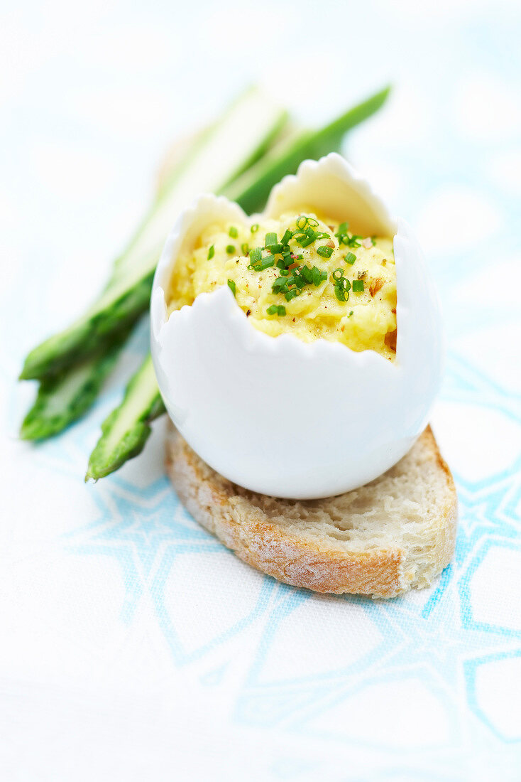 Scrambled eggs with chives served in an eggshell