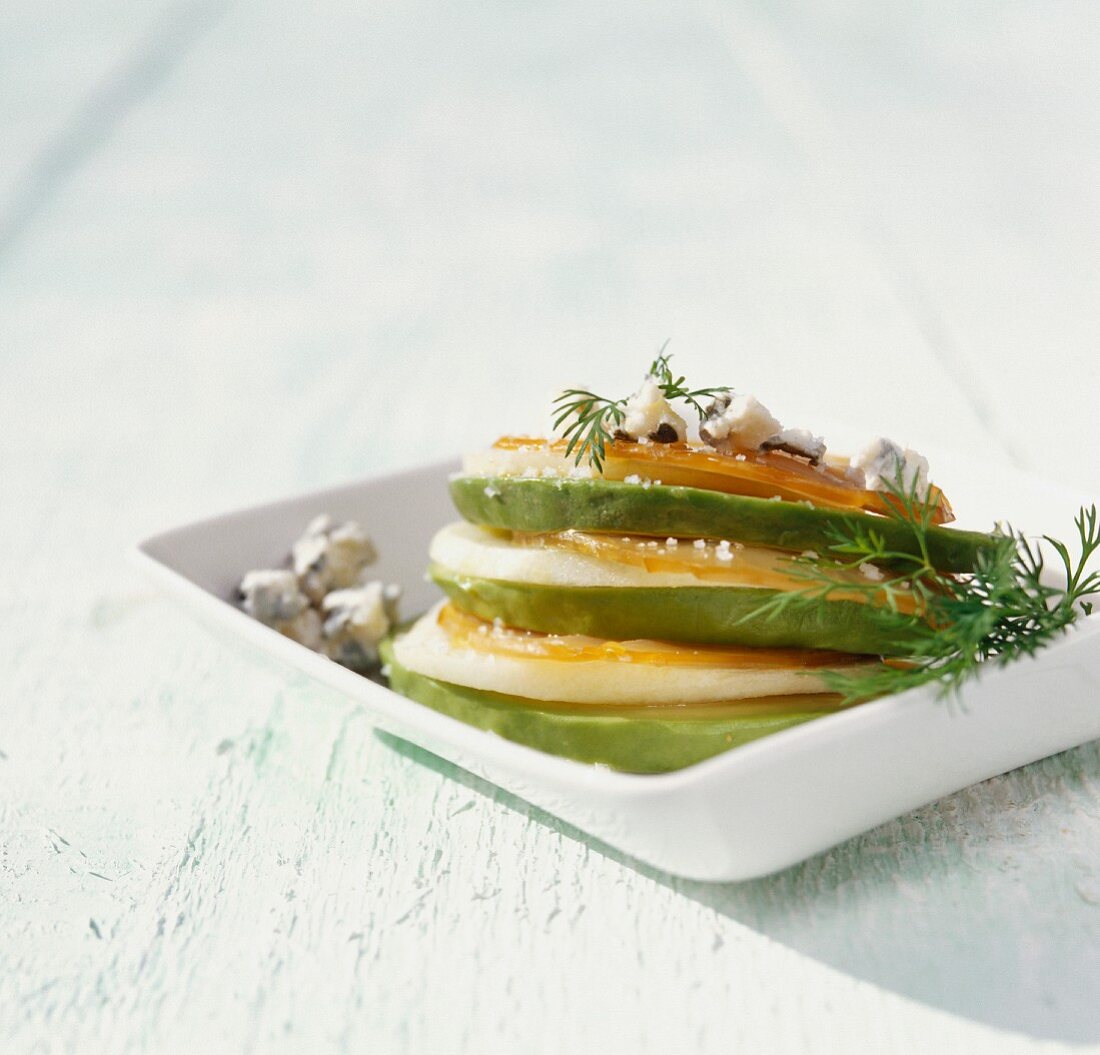 A stack of avocado, pear, Roquefort and spearfish slices