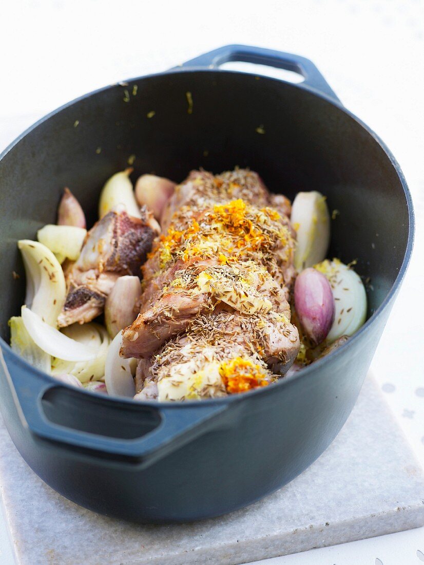 Veal roast with shallots and spices in a casserole dish