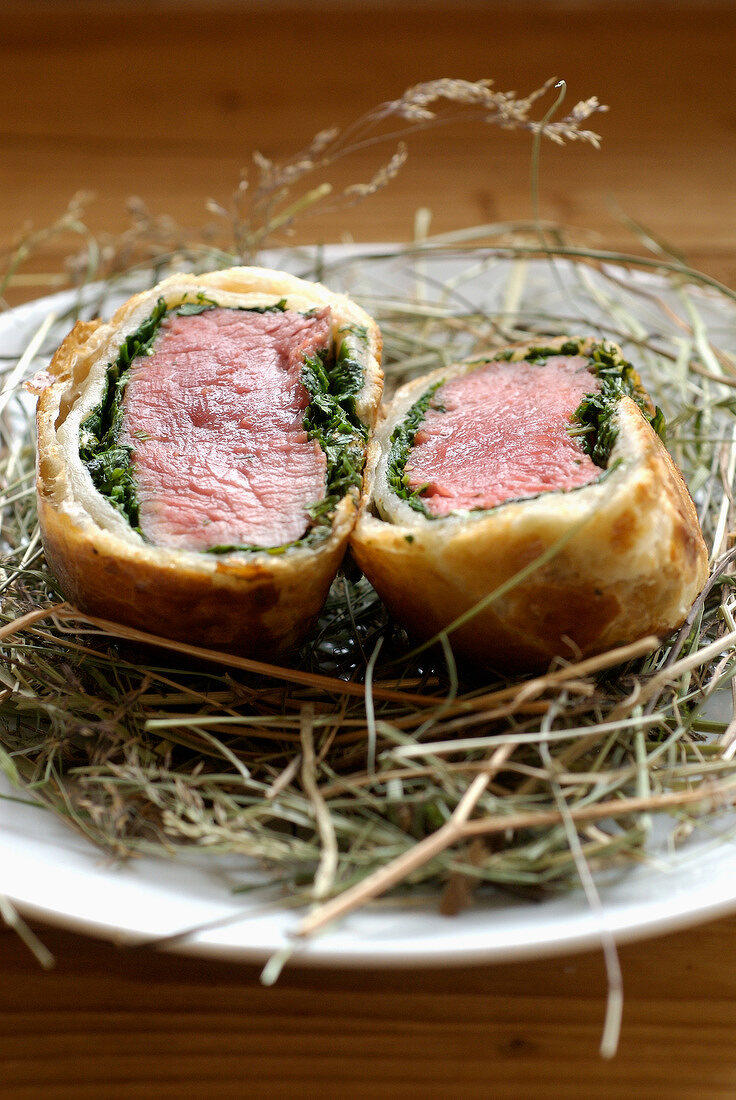 Beef fillet in pastry crust on a bed on hay