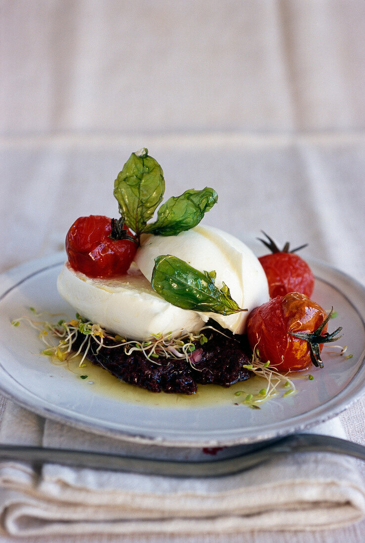 Mozzarella with tapenade and stewed cherry tomatoes