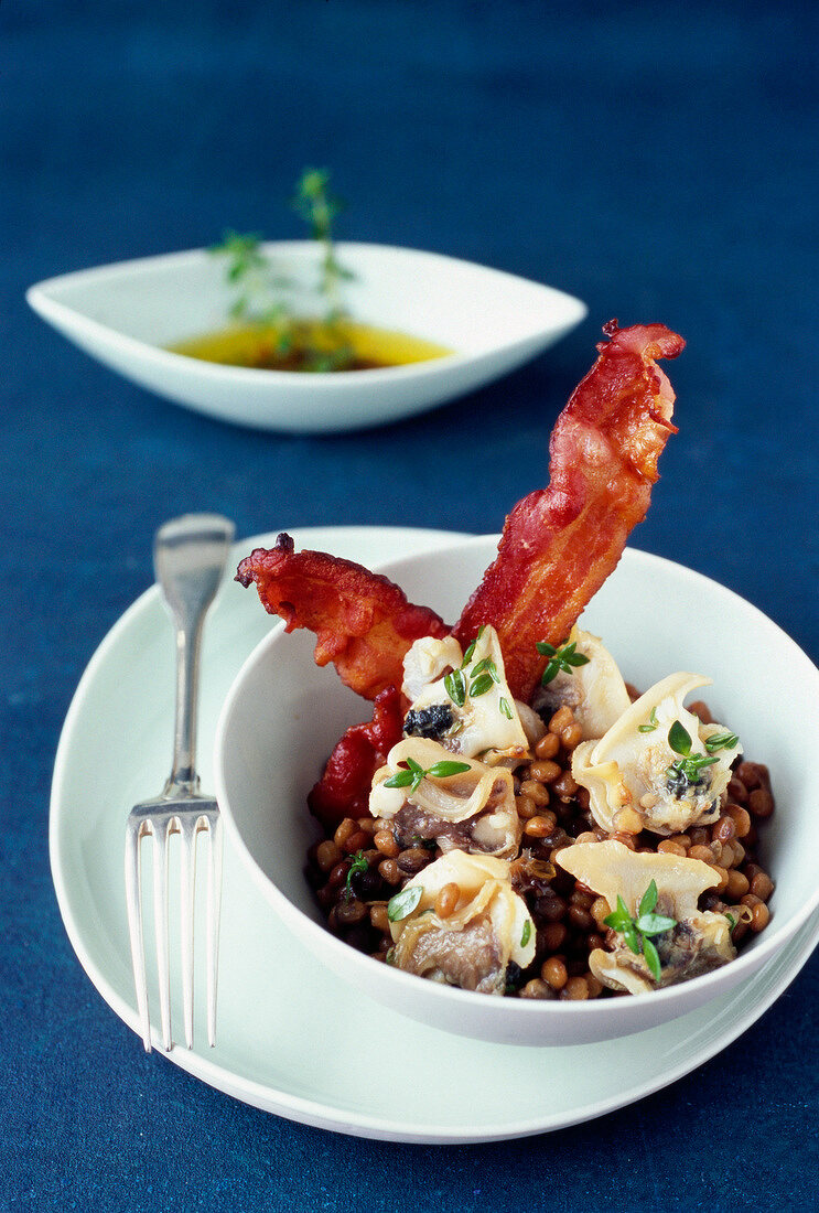 Dog cockel shellfish with lentils and bacon, chervil french dressing