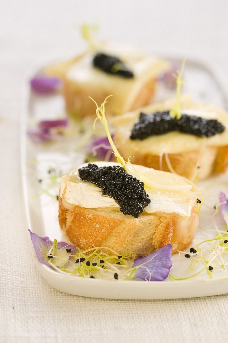 Camembert and caviar on a bite-size slice of bread