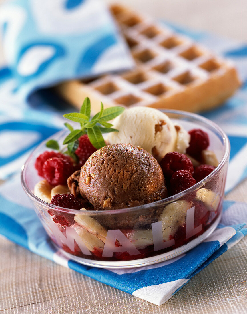 Dish of banana and hazelnut ice cream with fresh fruit