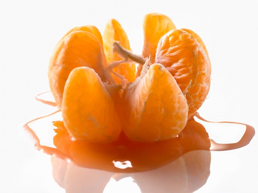 Peeled open clementine with juice