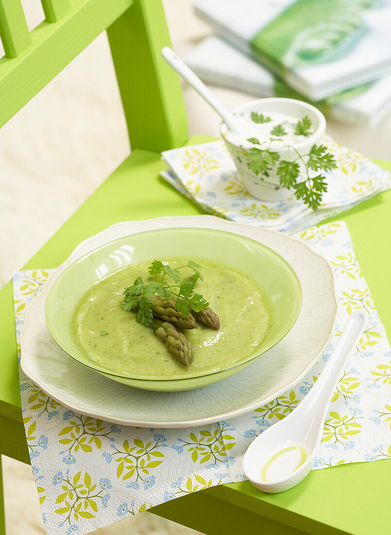 Cream of green asparagus soup with herbs