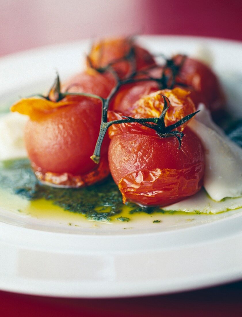 Bunch of roast tomatoes with balsamic vinegar, olive oil and mozzarella