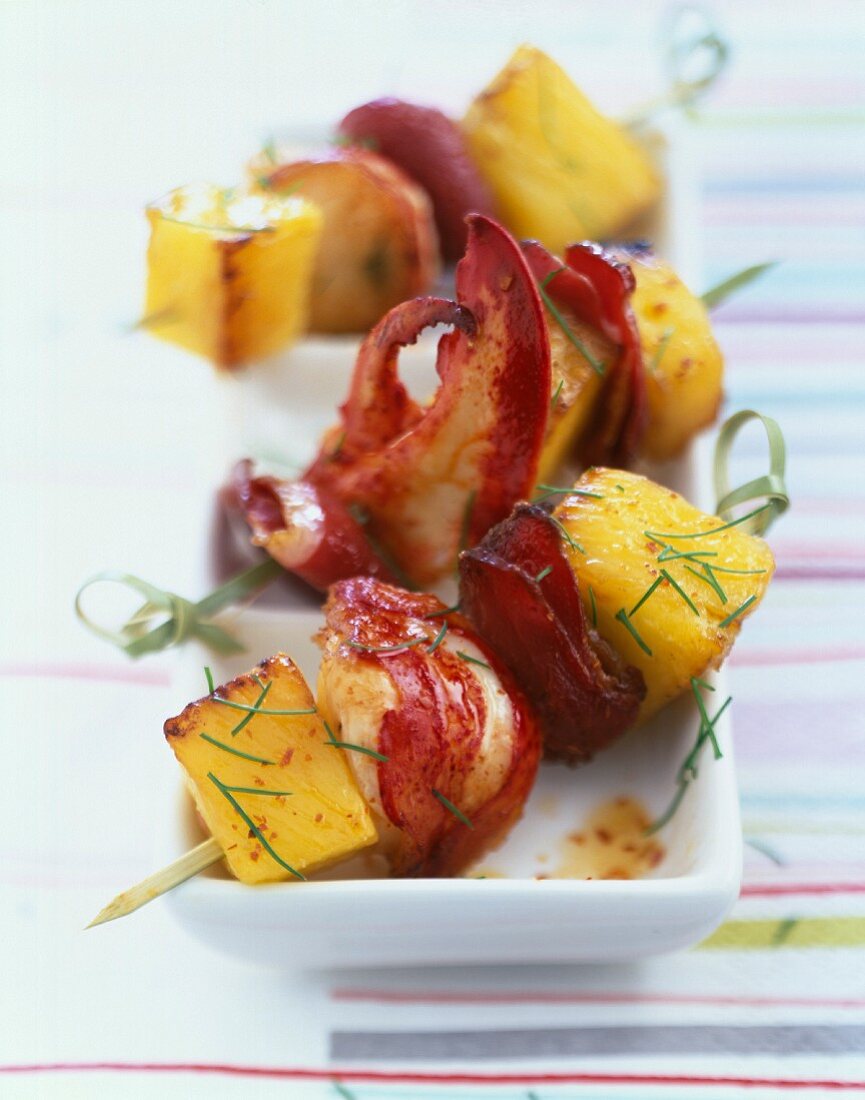 Lobster, duck magret and pineapple skewers