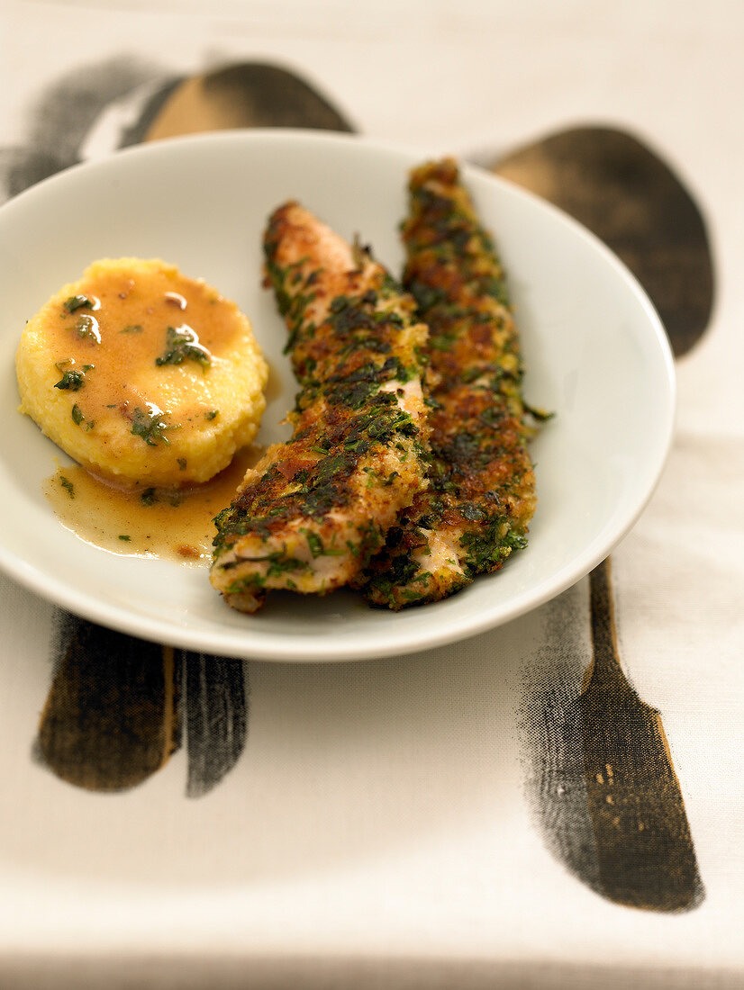 Sliced chicken breasts in breadcrumbs and herbs