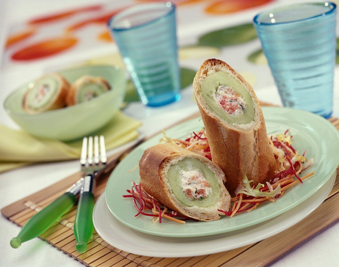 Baguette sections stuffed with cream cheese and cucumbers