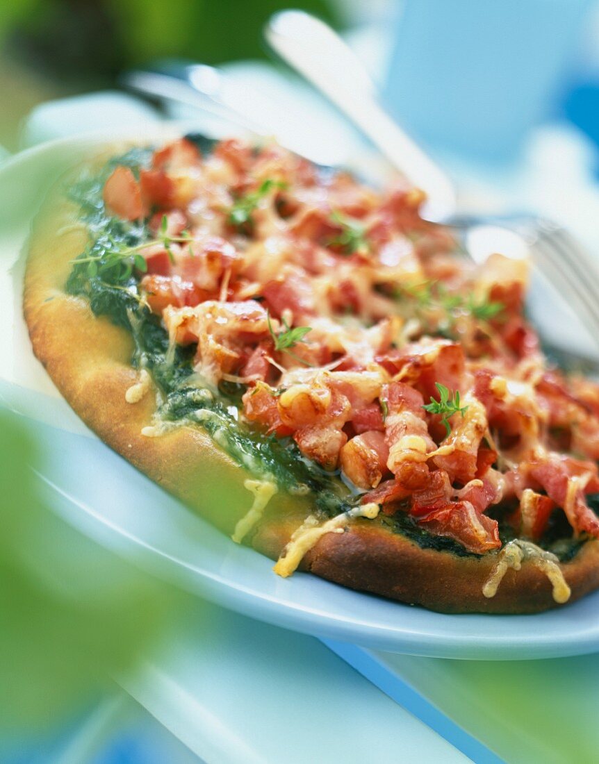 Spinach and diced bacon pizza
